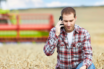 Long range DECT Phone shown being used outdoors on farmland.