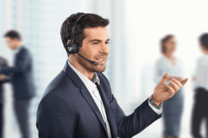 Man wearing a Jabra Engage 75 Headset whilst standing with co-workers int he background